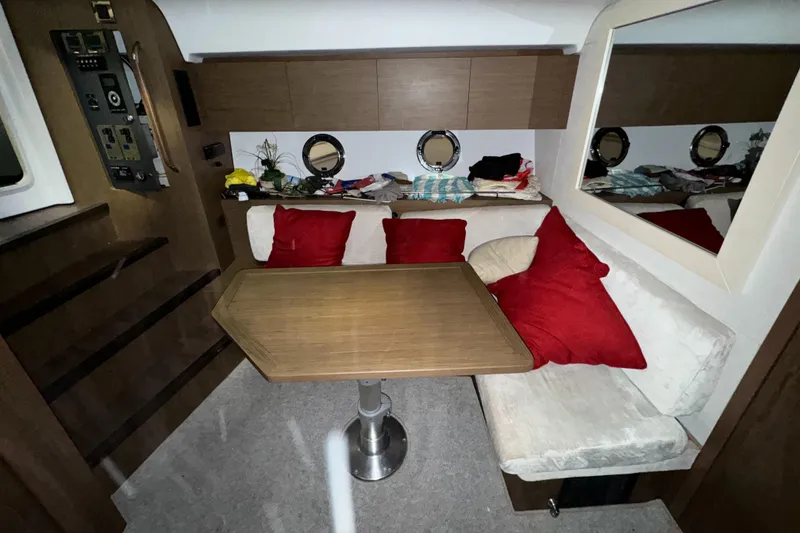 Slide: The Image of Interior of 2018 Beneteau 40 Gran Tourismo with cozy seating and wooden table. - 19