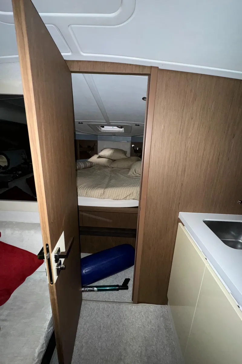 Slide: The Image of Interior cabin of 2018 Beneteau 40 Gran Tourismo yacht with bed and kitchenette. - 21