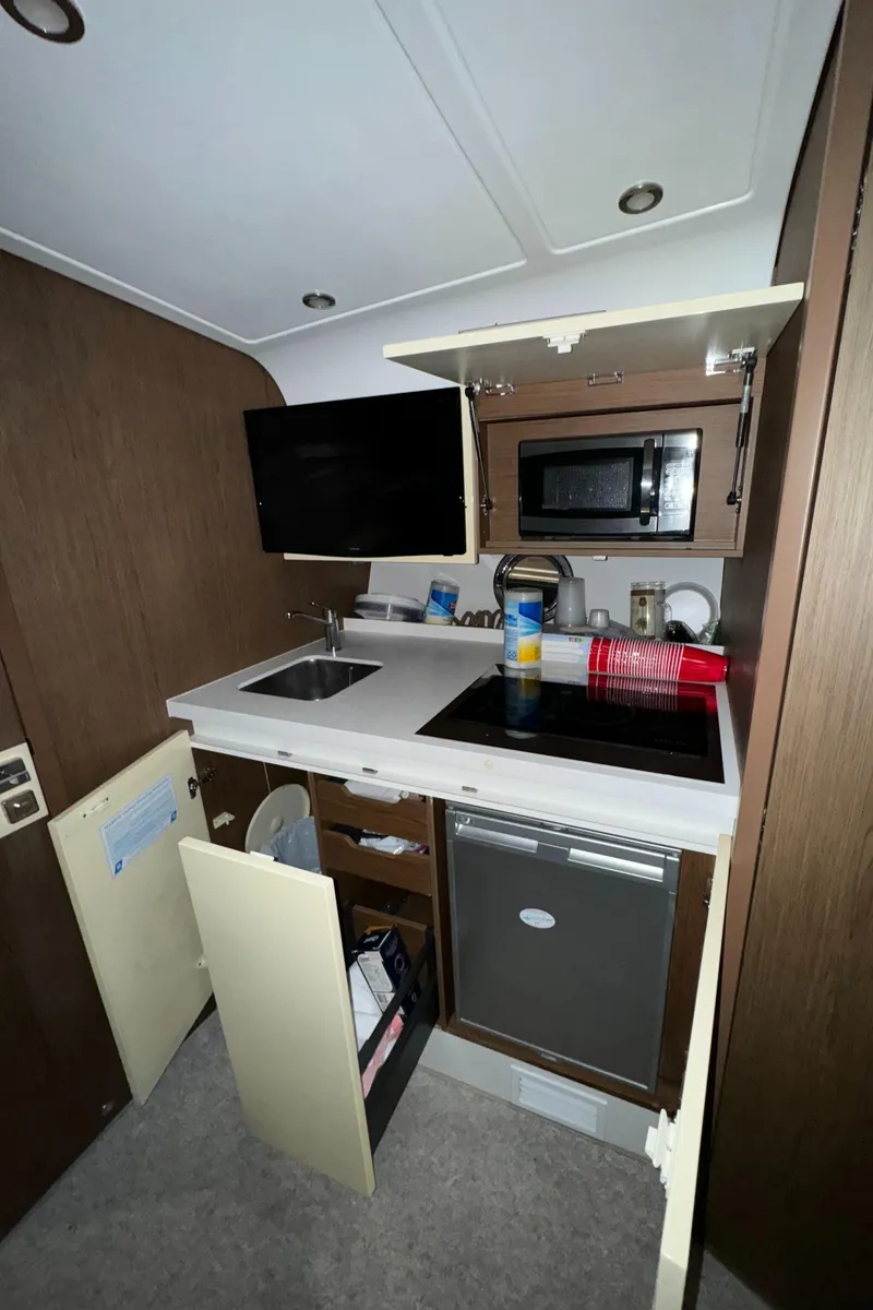 Slide: The Image of 2018 Beneteau 40 Gran Tourismo yacht kitchen with modern appliances and sleek cabinetry. - 23