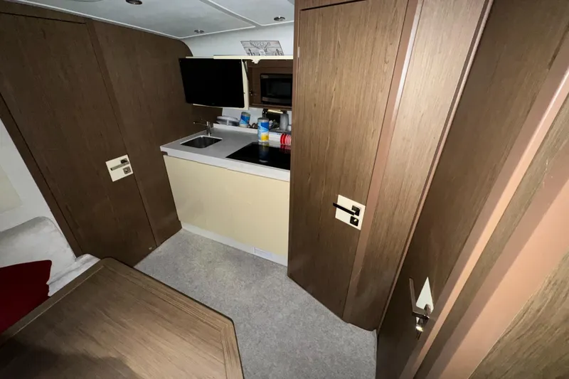 Slide: The Image of Interior of 2018 Beneteau 40 Gran Tourismo yacht with kitchenette and wood paneling. - 28