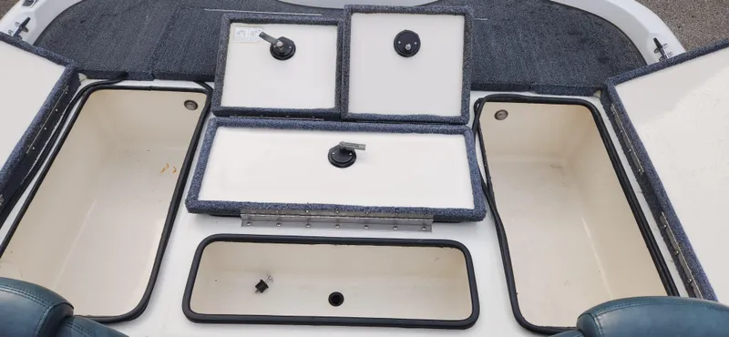 Slide: The Image of 2005 Ranger 520 VX boat storage compartments open. - 12