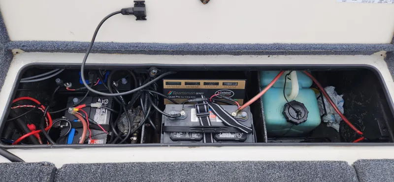 Slide: The Image of 2005 Ranger 520 VX boat battery compartment with wiring and components. - 13