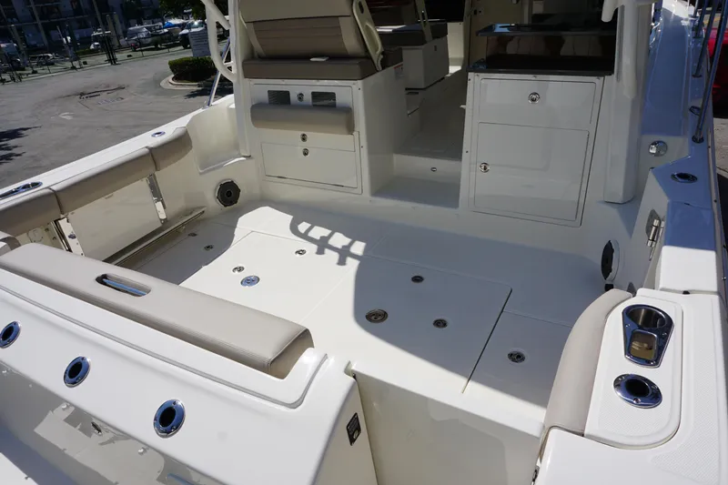 Slide: The Image of 2025 Boston Whaler 365 Conquest boat interior with seating and storage compartments. - 18