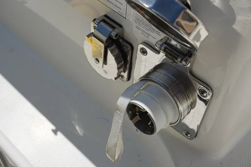 Slide: The Image of Close-up of a 2025 Boston Whaler 365 Conquest boat's electrical connection port. - 21