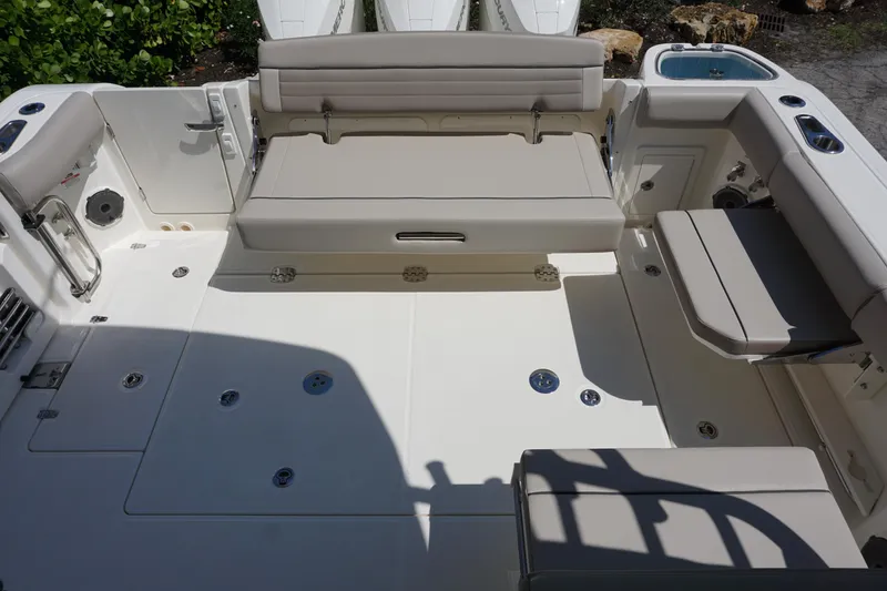Slide: The Image of 2025 Boston Whaler 365 Conquest boat deck with seating and storage compartments. - 23