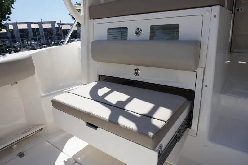 Slide: The Image of 2025 Boston Whaler 365 Conquest interior seating with storage compartment. - 24