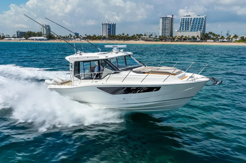 Slide: The Image of 2025 Boston Whaler 365 Conquest cruising on ocean near city skyline. - 3