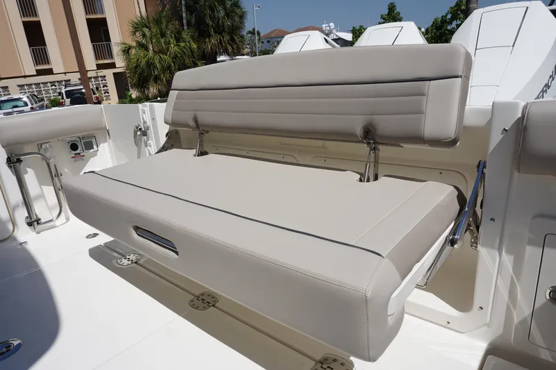Slide: The Image of 2025 Boston Whaler 365 Conquest boat with beige foldable seating in the deck area. - 32