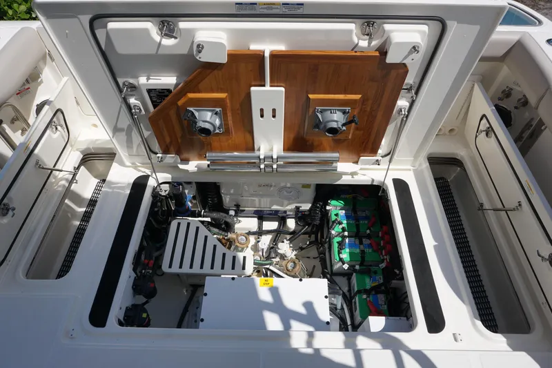 Slide: The Image of Engine compartment of 2025 Boston Whaler 365 Conquest, showcasing mechanical components and battery setup. - 39