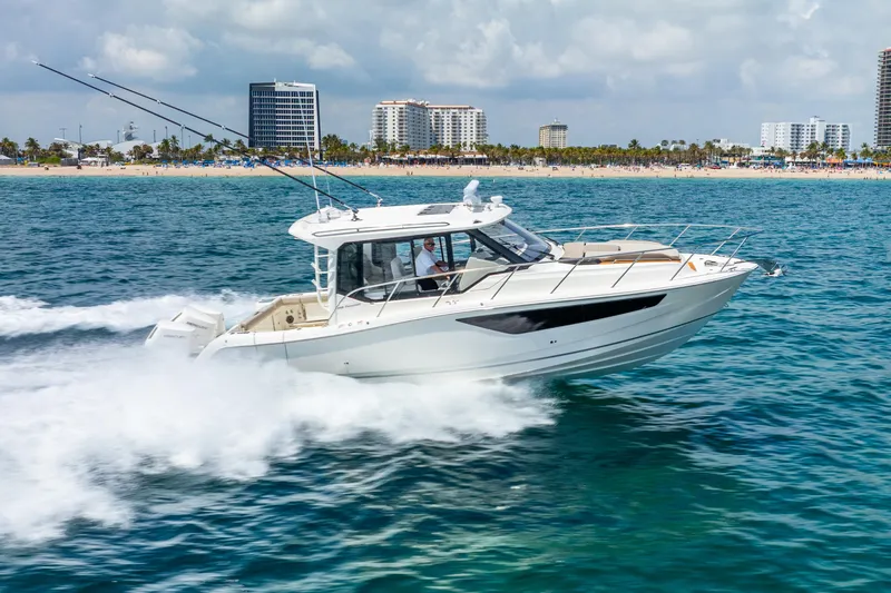 Slide: The Image of 2025 Boston Whaler 365 Conquest cruising on ocean near city skyline. - 4