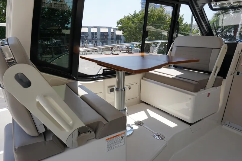 Slide: The Image of Interior of 2025 Boston Whaler 365 Conquest, featuring seating and a wooden table. - 40