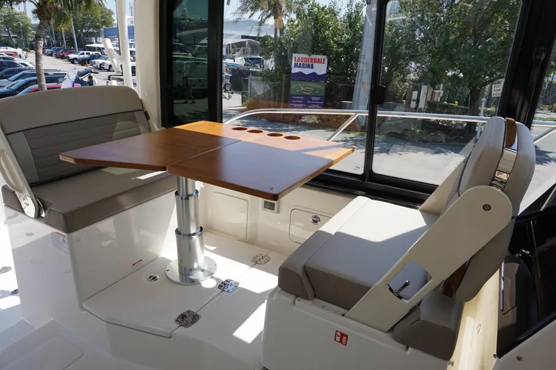 Slide: The Image of 2025 Boston Whaler 365 Conquest interior with seating and wooden table. - 41