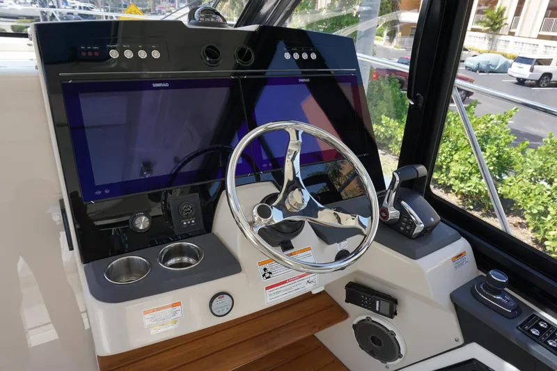 Slide: The Image of Helm of 2025 Boston Whaler 365 Conquest with modern controls and navigation screens. - 43