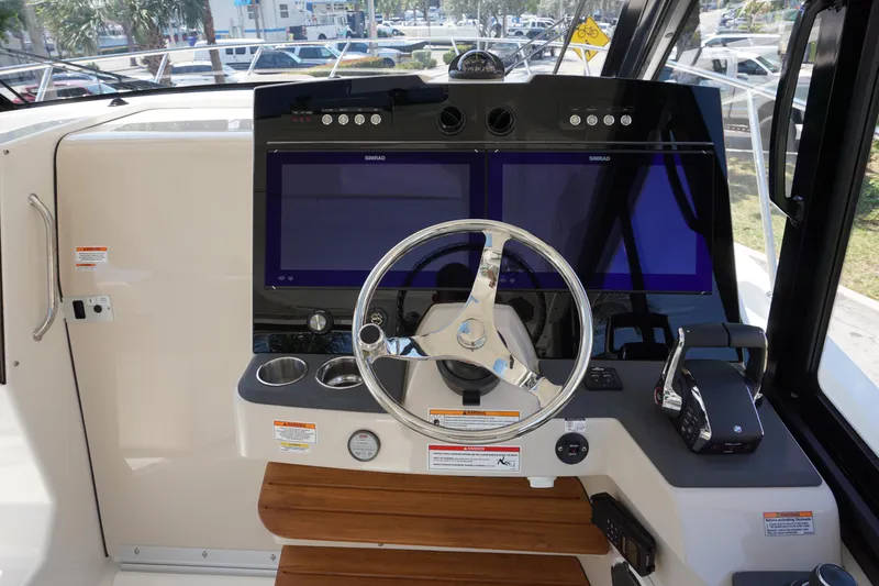 Slide: The Image of Helm of 2025 Boston Whaler 365 Conquest with dual screens and modern controls. - 44