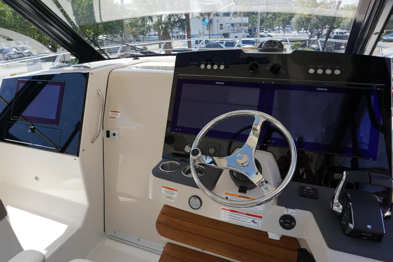 Slide: The Image of Helm of 2025 Boston Whaler 365 Conquest with modern navigation displays and controls. - 45