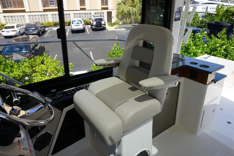 Slide: The Image of 2025 Boston Whaler 365 Conquest helm seat with steering wheel, showcasing luxury and comfort. - 46