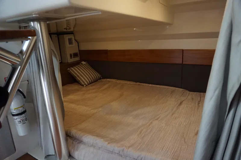 Slide: The Image of 2025 Boston Whaler 365 Conquest cabin interior with cozy bed and modern design. - 56