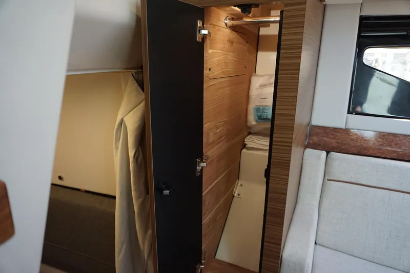 Slide: The Image of Interior cabin of 2025 Boston Whaler 365 Conquest, featuring closet and seating area. - 59