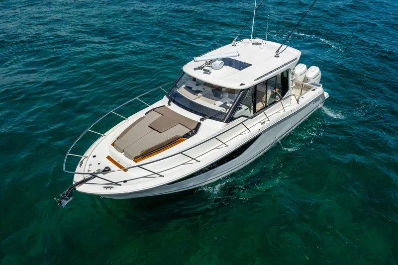 Slide: The Image of 2025 Boston Whaler 365 Conquest cruising on clear blue water. - 6
