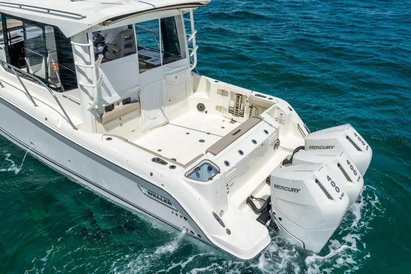 Slide: The Image of 2025 Boston Whaler 365 Conquest boat with dual Mercury engines on open water. - 9