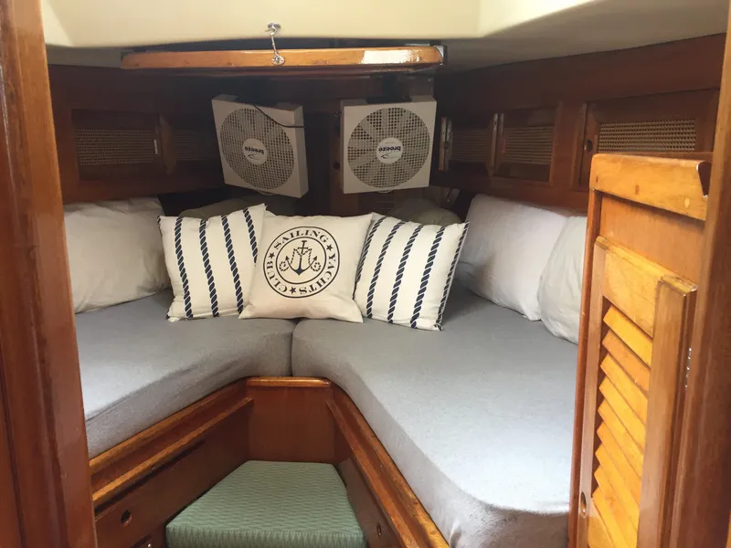 Slide: The Image of Cozy cabin interior of 1980 Bristol 35.5 sailboat with nautical-themed pillows. - 26