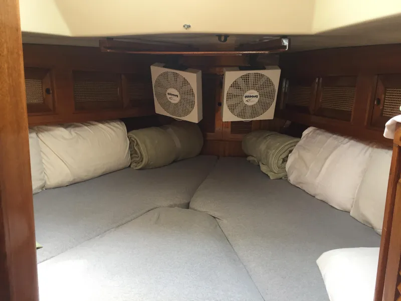 Slide: The Image of Cozy cabin interior of a 1980 Bristol 35.5 sailboat with bedding and fans. - 27