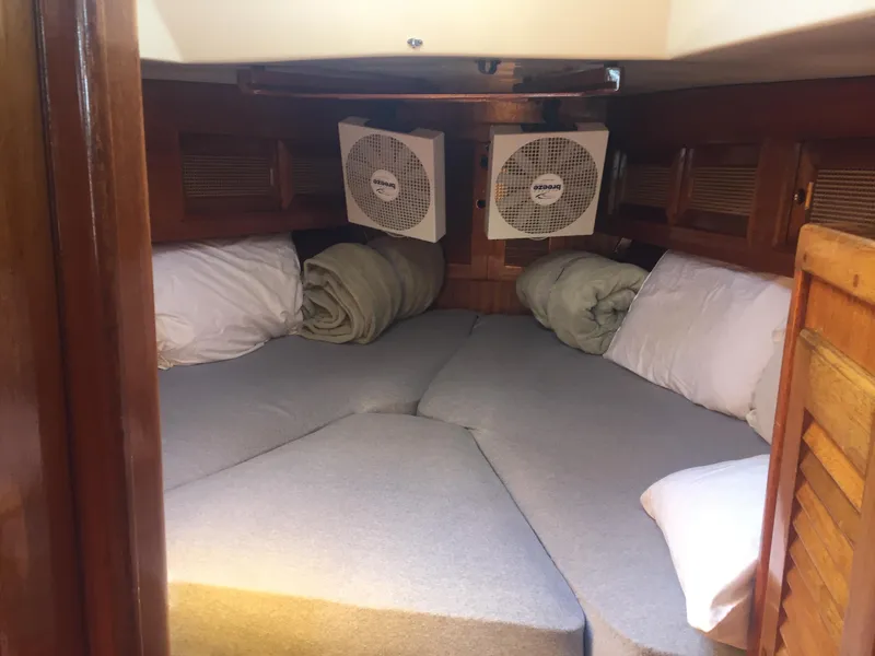 Slide: The Image of Cozy cabin interior of a 1980 Bristol 35.5 sailboat with V-berth bedding. - 29