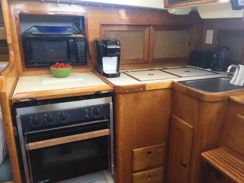 Slide: The Image of 1980 Bristol 35.5 boat kitchen with microwave, oven, sink, and coffee maker. - 36