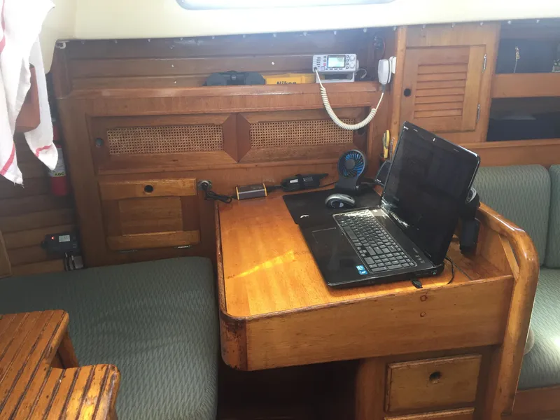 Slide: The Image of 1980 Bristol 35.5 sailboat interior with wooden desk and laptop. - 38