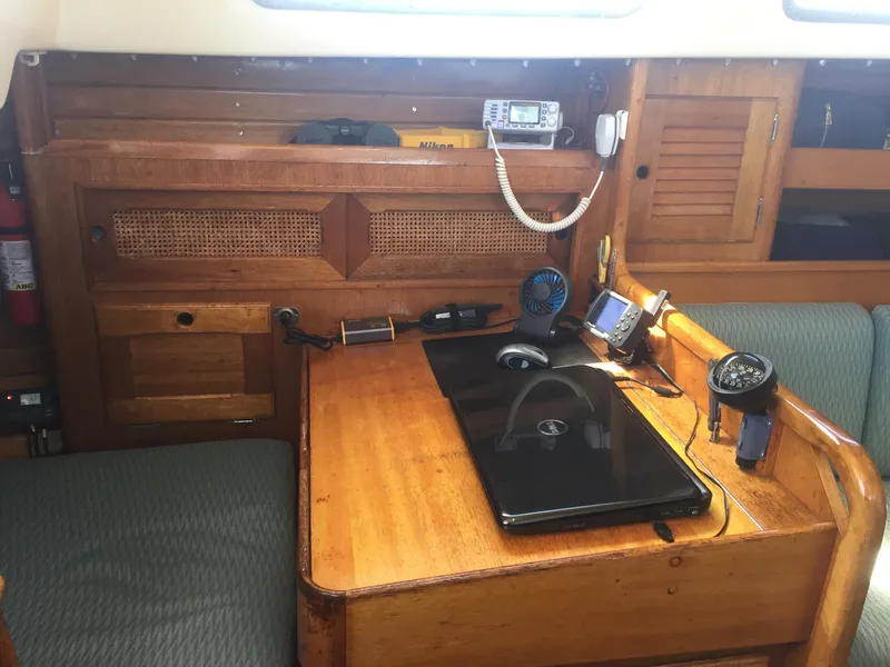 Slide: The Image of 1980 Bristol 35.5 sailboat navigation station with laptop and marine radio. - 39