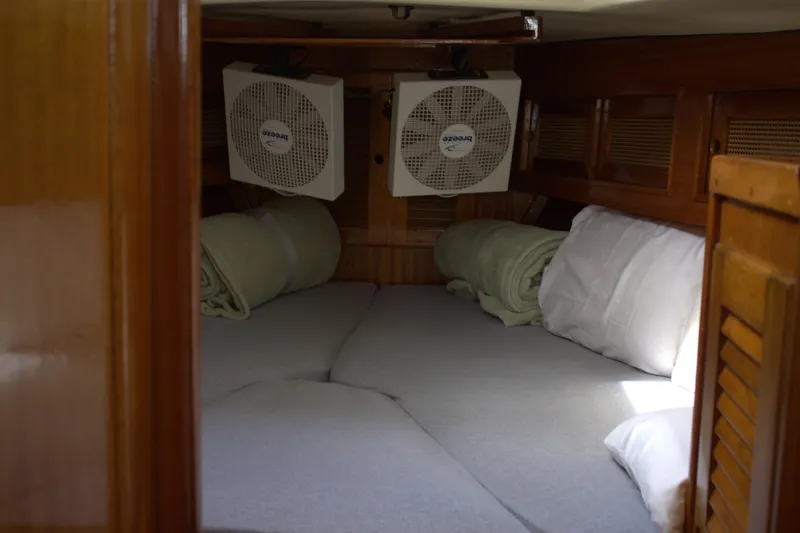 Slide: The Image of Cozy cabin interior of a 1980 Bristol 35.5 sailboat with fans and bedding. - 41