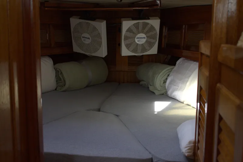 Slide: The Image of 1980 Bristol 35.5 sailboat interior cabin with fans and bedding. - 42