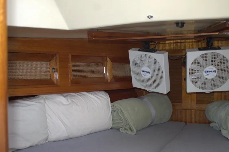 Slide: The Image of Cozy cabin interior of 1980 Bristol 35.5 sailboat with fans and bedding. - 43