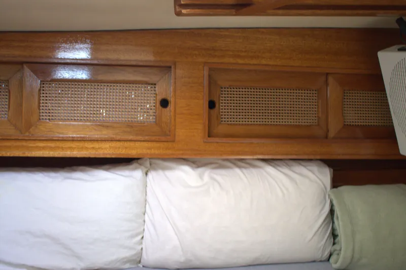 Slide: The Image of Wooden interior of 1980 Bristol 35.5 sailboat with pillows and storage compartments. - 45