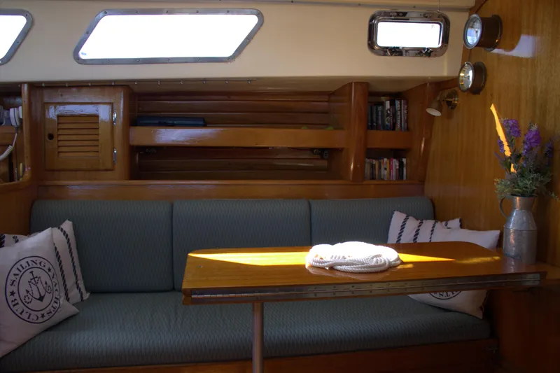 Slide: The Image of Interior of a 1980 Bristol 35.5 sailboat with cozy seating and wooden table. - 49