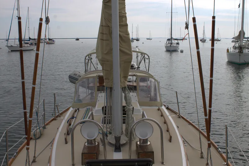 Slide: The Image of 1980 Bristol 35.5 sailboat docked in a calm marina with other boats. - 9