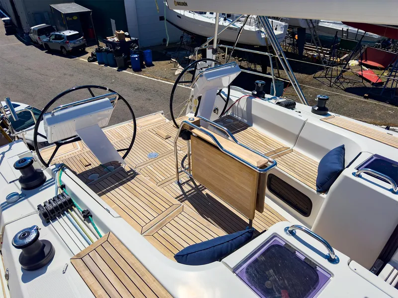 Slide: The Image of 2014 Hanse 445 sailboat cockpit with dual steering wheels and teak decking. - 11