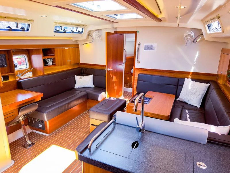 Slide: The Image of Luxurious interior of 2014 Hanse 445 sailboat with modern kitchen and cozy seating area. - 23