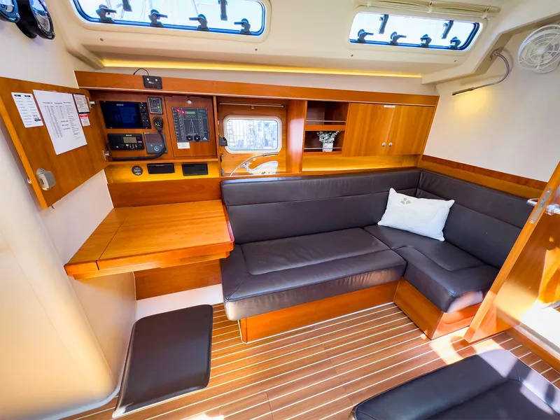 Slide: The Image of Interior of 2014 Hanse 445 sailboat with wooden furnishings and black seating. - 28