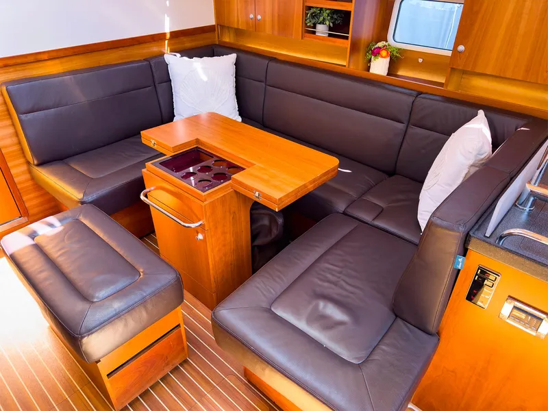Slide: The Image of Interior of 2014 Hanse 445 yacht with leather seating and wooden table. - 30