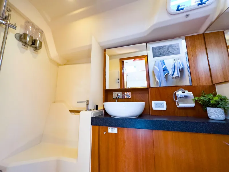 Slide: The Image of Modern bathroom in 2014 Hanse 445 yacht with wooden cabinetry and white fixtures. - 33