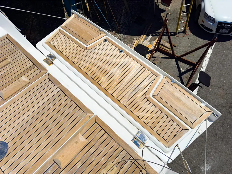 Slide: The Image of 2014 Hanse 445 yacht deck with wooden finish and storage compartments. - 7