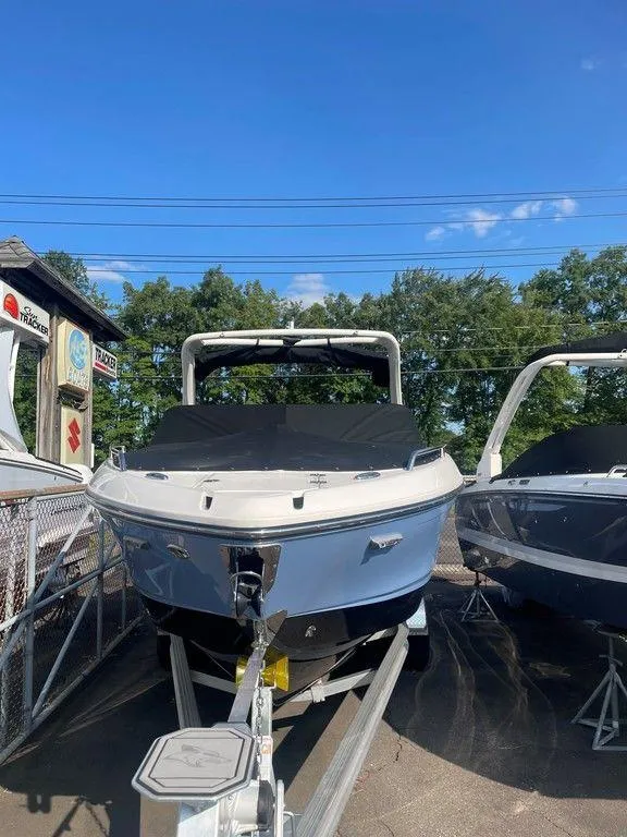 Slide: The Image of 2024 Chaparral 267 SSX boat on trailer under clear blue sky. - 10