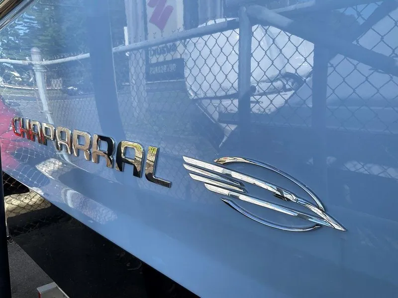 Slide: The Image of 2024 Chaparral 267 SSX boat logo on blue hull. - 14