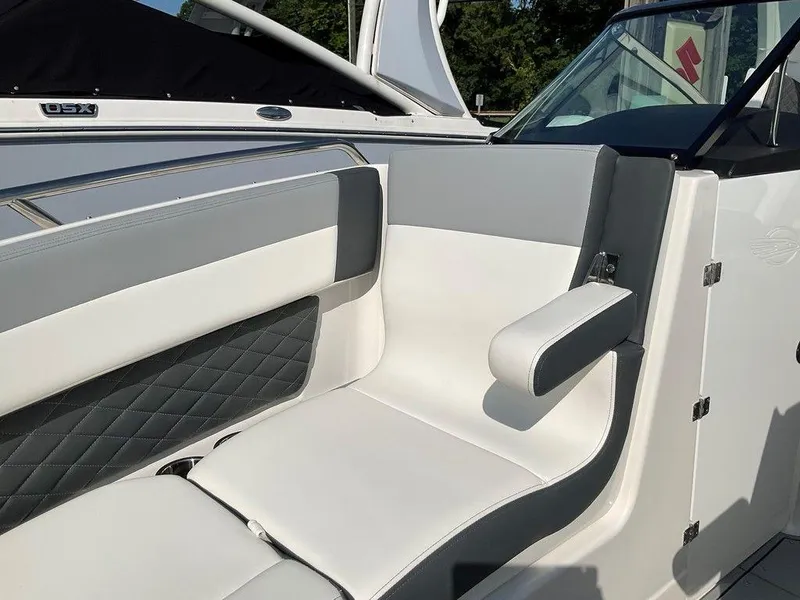 Slide: The Image of 2024 Chaparral 267 SSX boat interior with white and gray seating. - 17