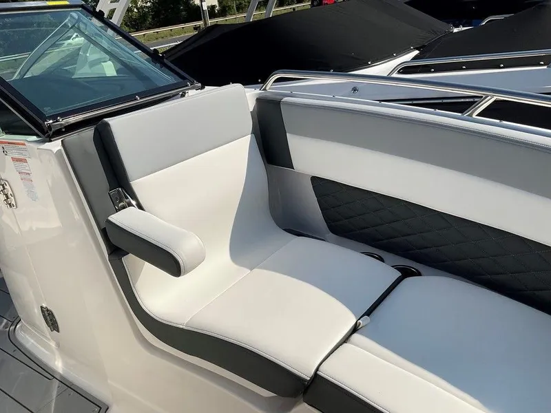 Slide: The Image of 2024 Chaparral 267 SSX boat interior with sleek white and black seating. - 19