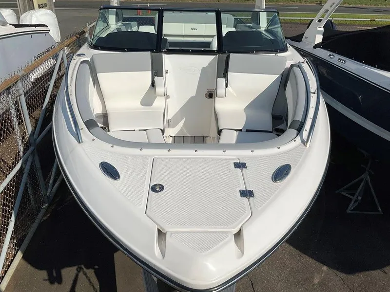 Slide: The Image of 2024 Chaparral 267 SSX boat with sleek white interior and spacious seating. - 21