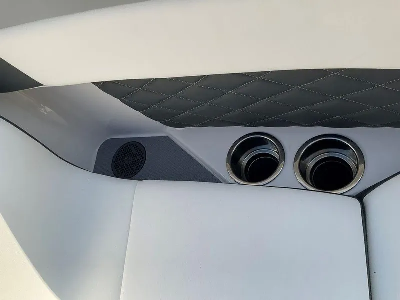 Slide: The Image of 2024 Chaparral 267 SSX interior with quilted upholstery and dual cup holders. - 25