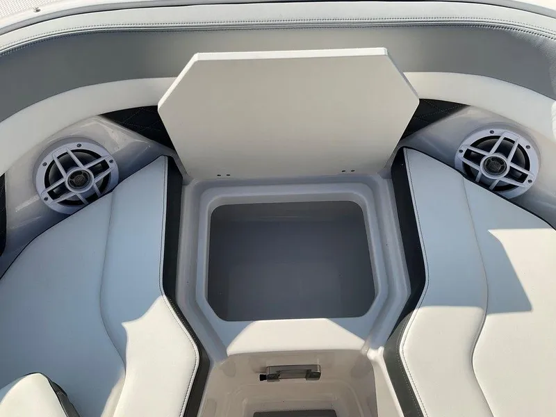 Slide: The Image of 2024 Chaparral 267 SSX boat interior with storage compartment and speakers. - 29