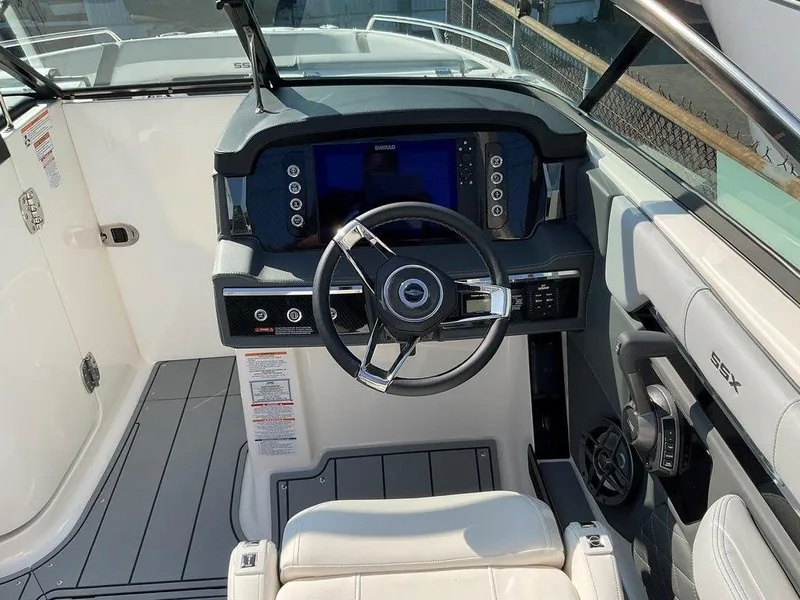 Slide: The Image of 2024 Chaparral 267 SSX boat helm with modern dashboard and steering wheel. - 32